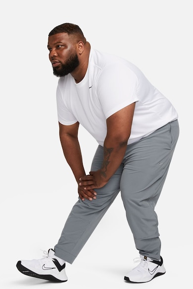 Nike Pantaloni conici cu tehnologie Dri-FIT si slituri cu fermoar Unlimited Barbati