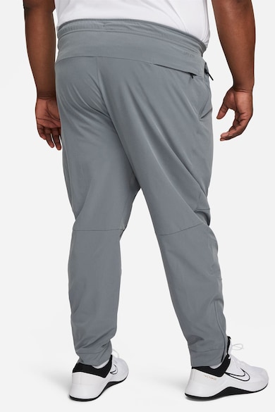 Nike Pantaloni conici cu tehnologie Dri-FIT si slituri cu fermoar Unlimited Barbati