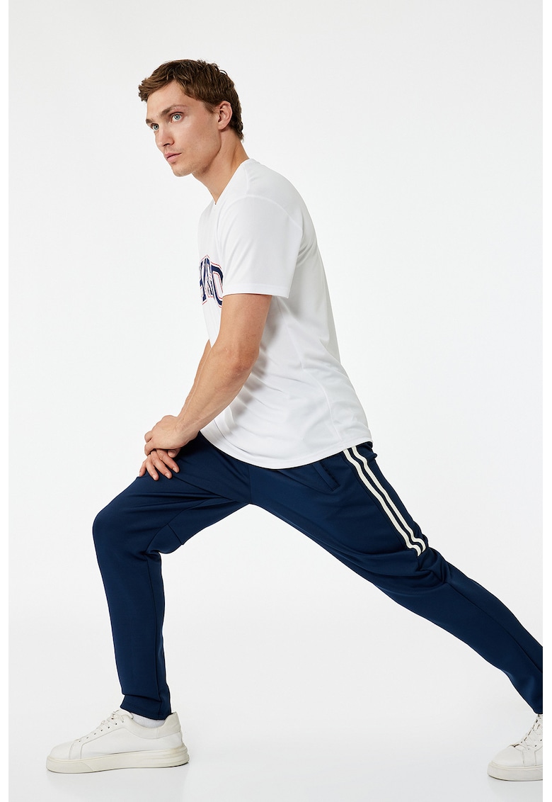 Pantaloni conici de trening cu dungi laterale