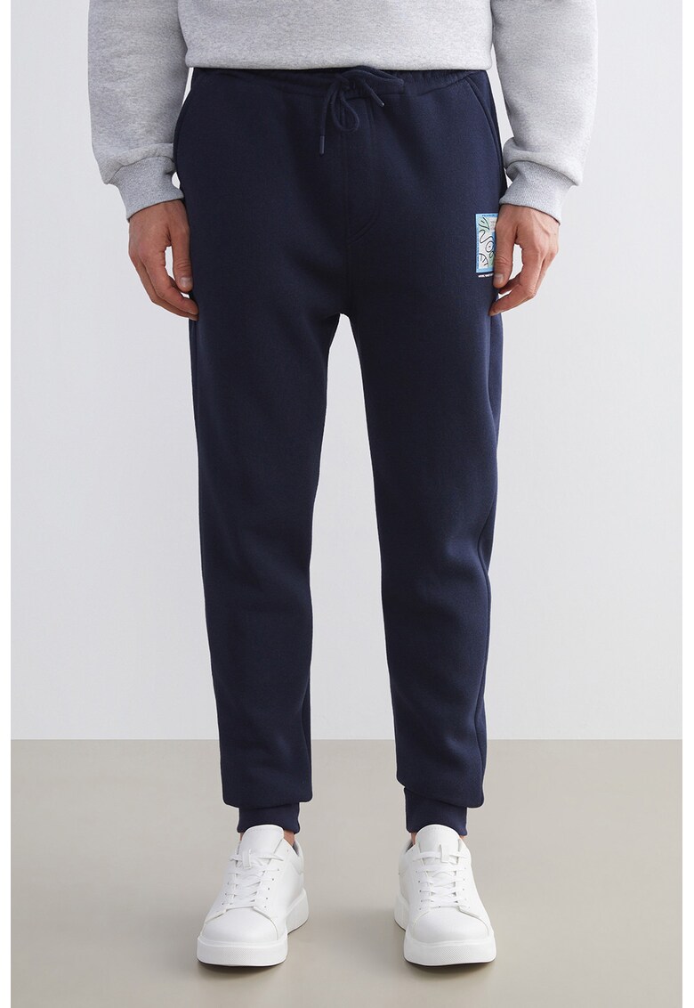 Pantaloni de trening cu croiala conica si doua buzunare oblice - Bleumarin