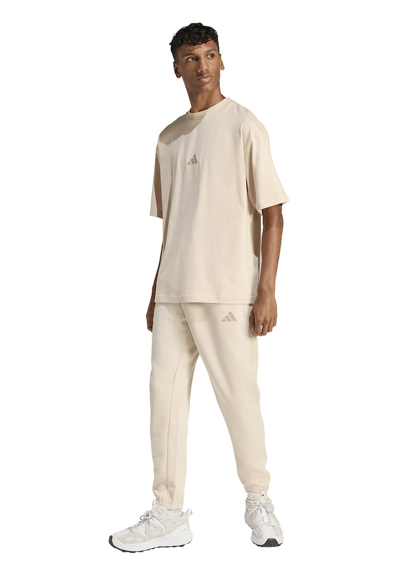 Pantaloni de trening conici cu buzunare laterale - Crem