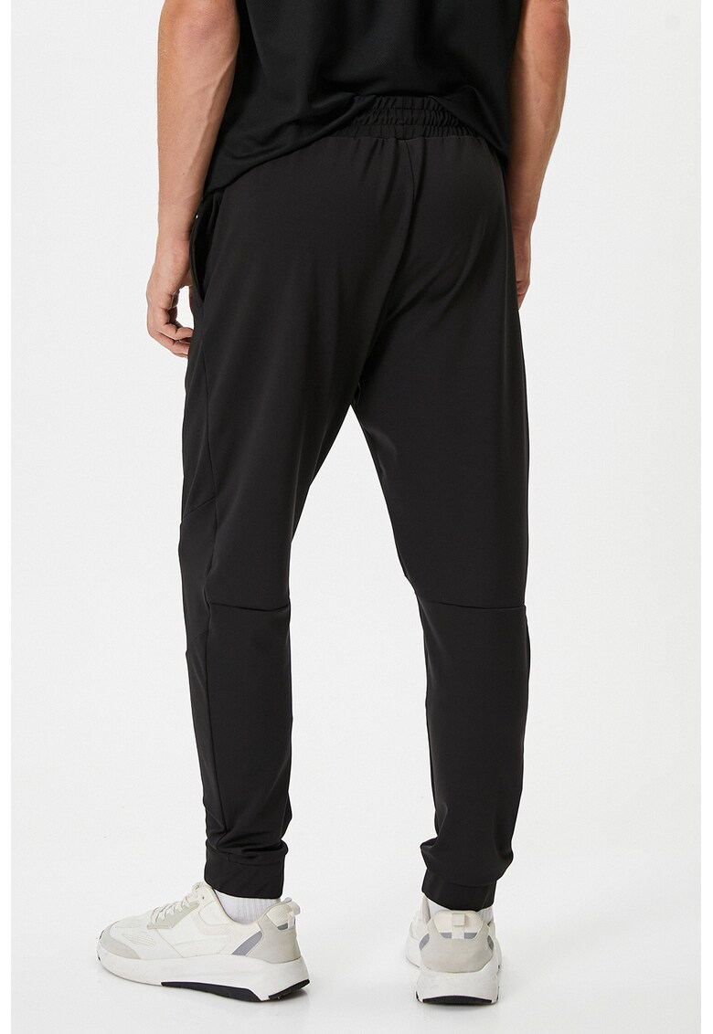 Pantaloni de trening uni cu buzunare laterale