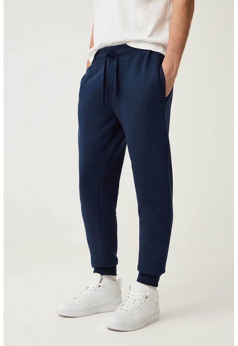 Pantaloni de trening cu croiala conica si snur de ajustare