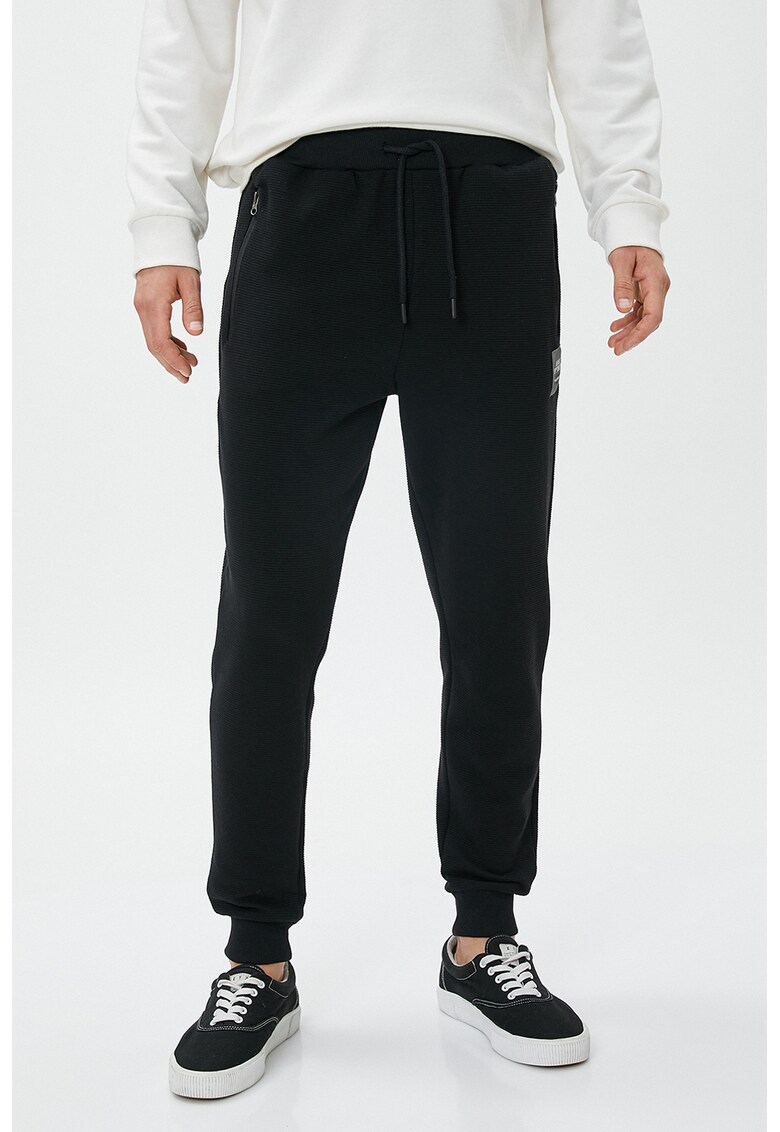 Pantaloni de trening striati cu buzunare laterale
