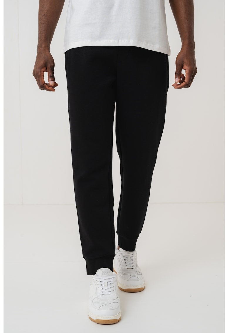 Pantaloni conici de trening