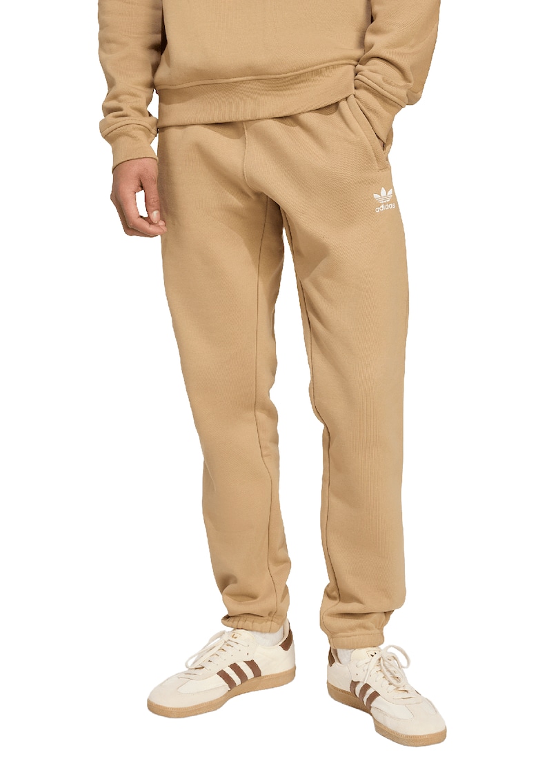 Pantaloni de trening cu croiala conica si banda elastica in talie