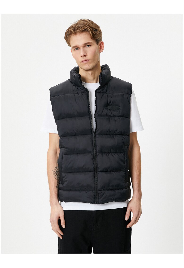 Vesta pufoasa cu buzunare laterale