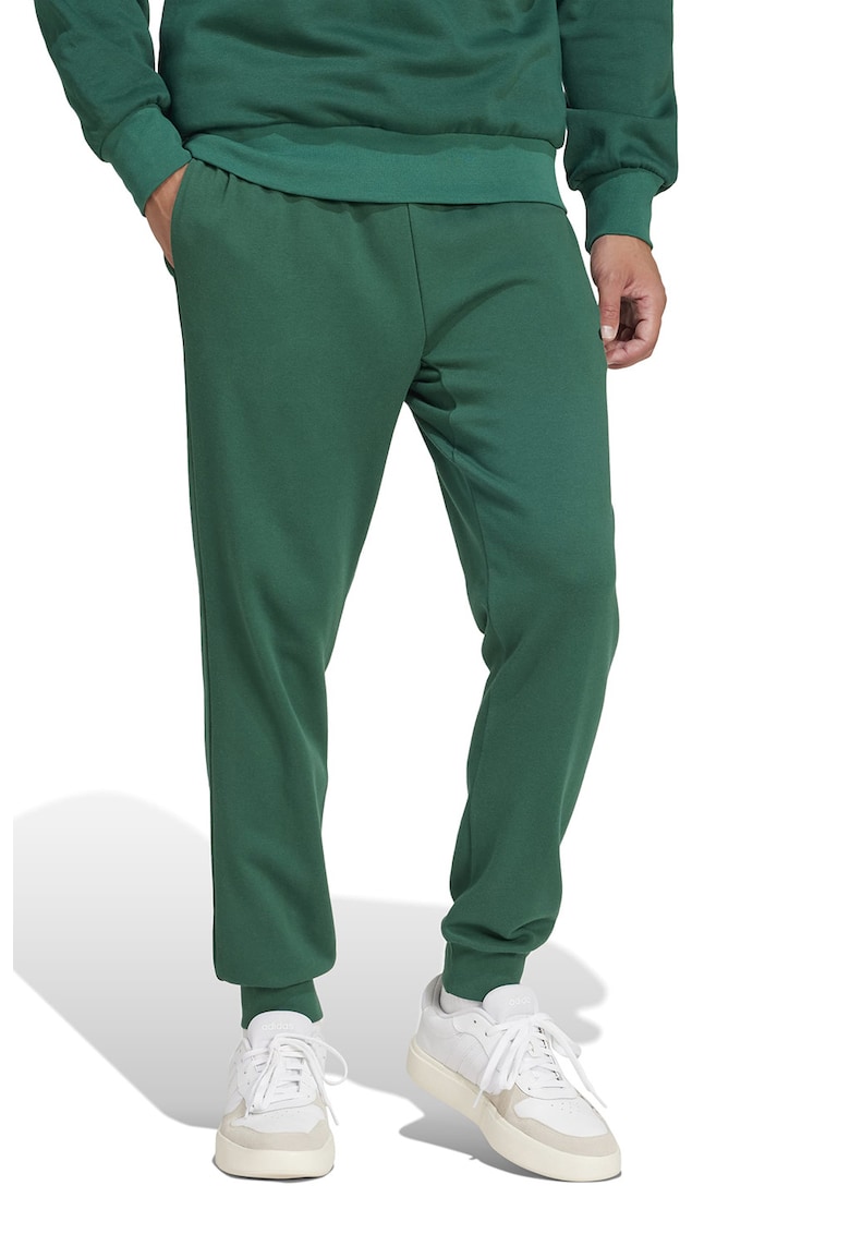 Pantaloni de trening conici cu buzunare laterale